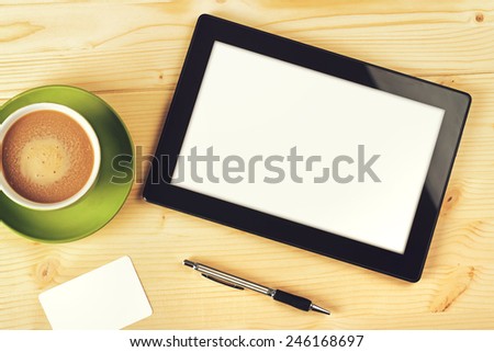 Top View of Tablet Computer With Blank White Screen as Copy Space on Office Table.