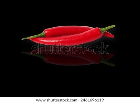 a close-up of a red chili pepper flower, showcasing its intricate details and vibrant color. The photo captures the beauty of the flower stage before the pepper grows