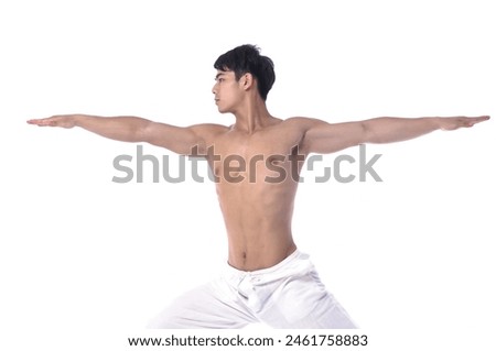 portrait of a young man in a yoga pose  in studio 