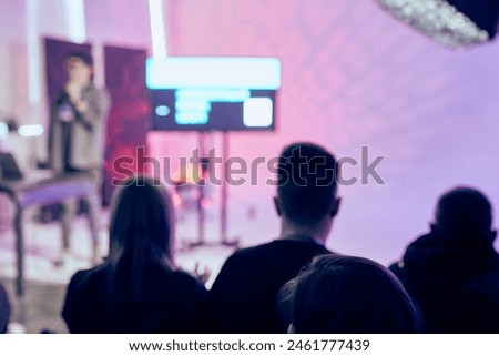 The student audience is in the conference room, listening to the speaker on a blurred background with a bokeh effect. The concept of a seminar, event, education with a copy space. High quality photo