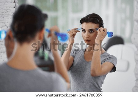 Facial skin care. A woman is doing a face massage using ice spheres. High quality photo