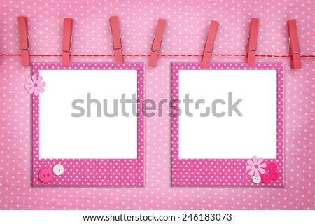 Pink photo frames hanging on a rope