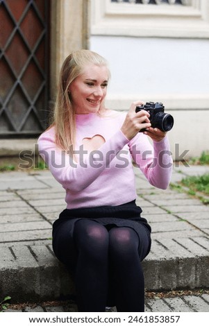 Attractive girl holding vintage camera in her hands. love to make a photos