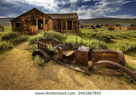 Abandoned memories: A weathered, rusted car stands in front of a desolate, deserted house, painting a picture of a forgotten past.