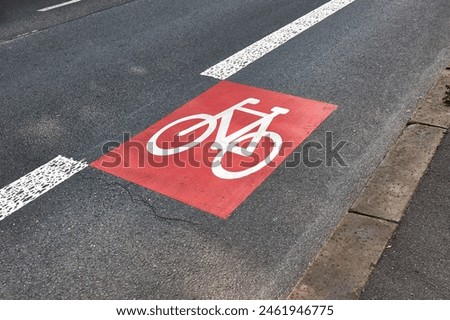 Bicycle lane sign on road asphalt surface