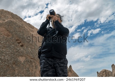 Photographer who captured the Devrent valley, one of the most beautiful valleys of Cappadocia. Aka a tourist in Dream Valley. male model tours the valley and takes photos.