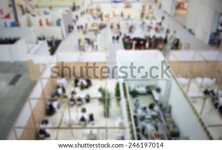 People at trade show, panoramic view. Intentionally blurred post production.
