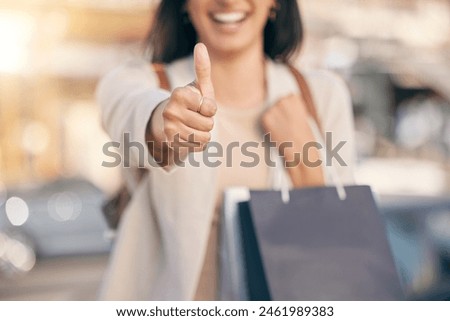 Woman, hand and shopping with thumbs up in city for deal, discount or sale in New York. Closeup, customer and emoji sign for yes at boutique and like luxury store, fashion or success in purchase