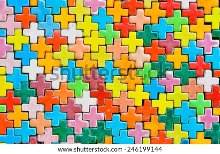 Multicolored tile shape of a cross on the wall