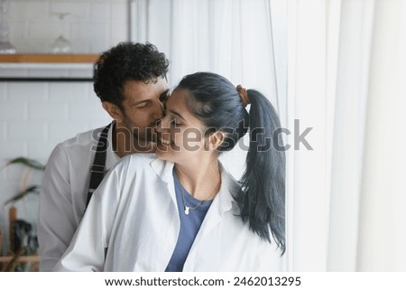 man and woman in kitchen, Couple chef cooking in kitchen at home. Male and female Hug in a sweet shop. Couple bakery owner.