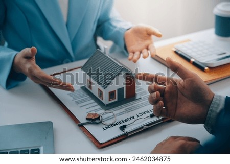 Real estate agent talked about the terms of the home purchase agreement and asked the customer to sign the documents to make the contract legally, Home sales and home insurance concept.