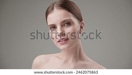 Beauty, health, cosmetics, anti-aging therapy and skin care concept - young beautiful brunette Caucasian woman posing and looking at the camera with a calm confident look