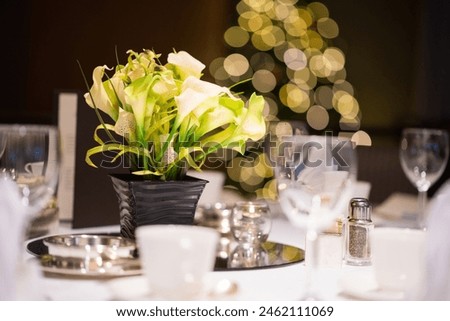 Enhance your event with the timeless beauty of this elegant white hydrangea centerpiece. Lush, full blooms arranged in a stylish vase exude sophistication and grace, making it the perfect addition