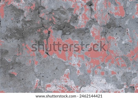 Peeling paint on the wall. Old concrete wall with cracked flaking paint. Weathered rough painted surface with patterns of cracks and peeling. High resolution texture for background and design. Closeup