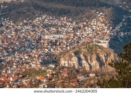 Sarajevo's cityscape unfolds in a picturesque view, with the white fortress contrasting against the vibrant colors of the Balkan landscape.