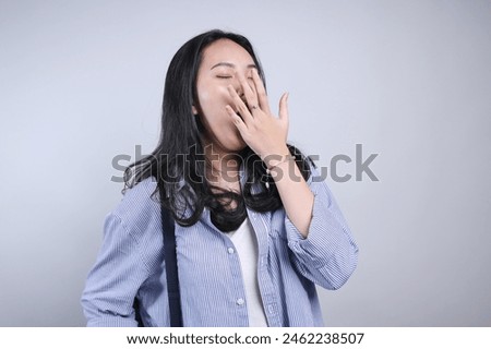 Potrait Of Young Asian Woman Yawning Cover Mouth With Hand Isolated On White Background