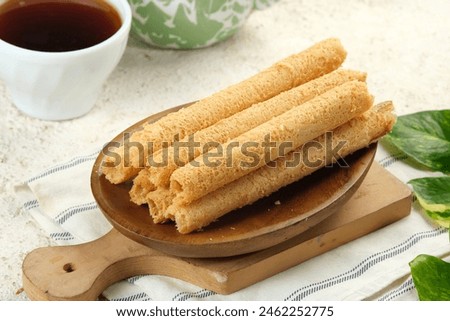 Egg Roll Biscuit or Kue Semprong or sapit, Simping, kue Belanda, or kapit or Love letters in English. It is an Indonesian traditional wafer snack Royalty-Free Stock Photo #2462252775
