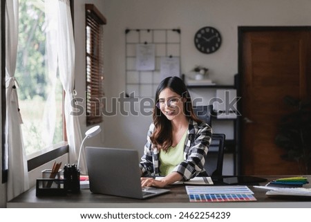 Female artist designer working graphic design with technology on laptop at creativity office.