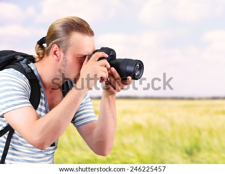 Young photographer taking photos outdoors