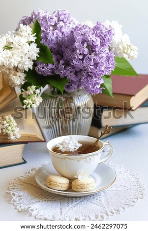 Cup of tea, bouquet of lilacs, spring still life.