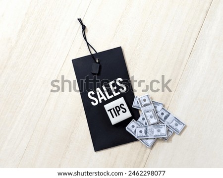 
label tag and miniature banknotes with text Sales Tips. business concept