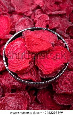 Close-up of Dried Beet Slices in Metal Bowl, High-resolution image showing a close-up of bright red dried beet slices in a metal bowl, ideal for healthy eating concepts.