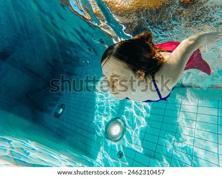 Pool. Mermaid girl swims underwater. Child's dream