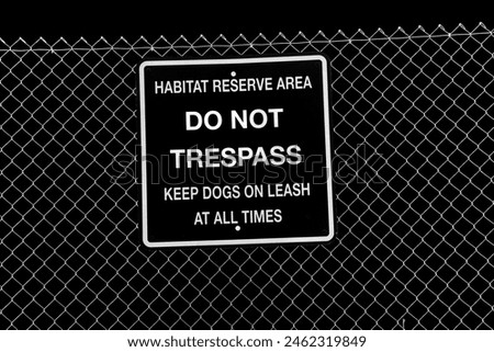 DO NOT TRESPASS. Warning Sign on a metal fence. DO NOT TRESPASS Sign. Habitat Reserve Area. Keep Dogs on Leash at All Times. Keep Out. Protected Land. Do not enter. Metal Sign. Rules and Regulations. 