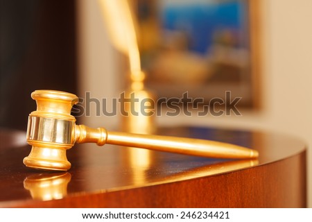 Juridical concept with hammer and pen , selective focus on metal part