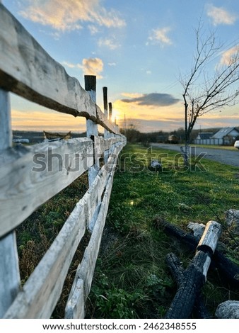 Fenced ranch at sunset, road to farm, Vertical photo