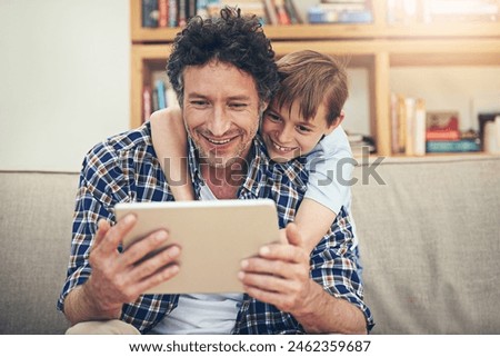 Happy, tablet and child hug father in home for watching movies, cartoons and online entertainment. Family, love and dad with son on digital tech for internet, video call and relax on weekend on sofa