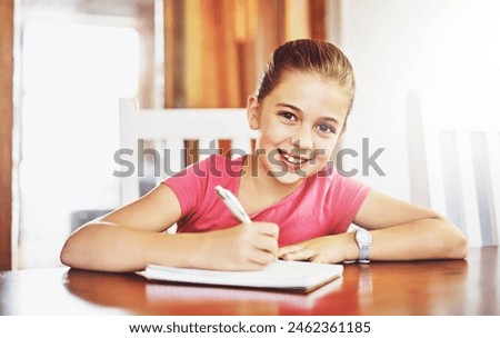 Portrait, happy child and writing at table for school, studying and education in house for knowledge. Notebook, girl and student for learning, exam and homeschool for development with pride