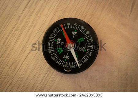 Photo of a compass on the ground background