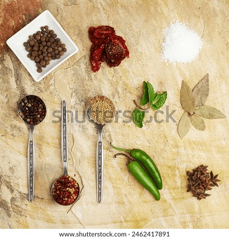 Top, herbs and spices with spoon isolated, exotic and ingredients for culinary dish and enhance flavor. Cutlery, colourful on counter for food preparation, Indian taste pallet with crushed seasoning