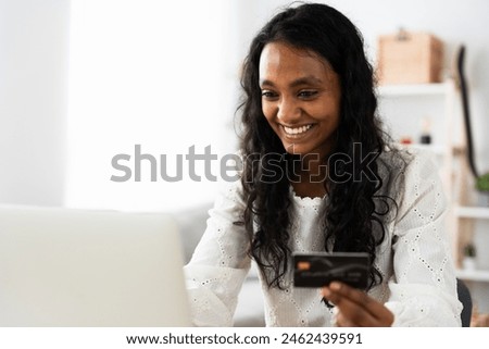 Real young Indian woman shopping online with copy space.