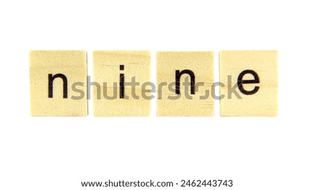 Short word english letter with text "nine" on a small wooden cubes block isolated on white background with clipping path.