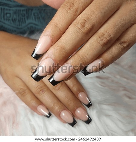 new trendy nail atrs on young women hand. Pink, black, red, green, blue  and purple color nails