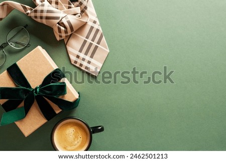 Happy Fathers Day card design. Top view gift box with green ribbon bow, glasses, tie, coffee cup on dark green background