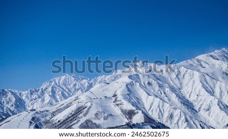 Northern Alps and clear skies in midwinter, Hakuba Village, Nagano Prefecture Royalty-Free Stock Photo #2462502675