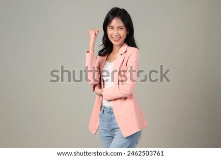 Enthusiastic asian woman rejoicing, say yes, looking happy and celebrating victory, champion dance, fist pump gesture, happy excited asian women cliching her fist on isolated background