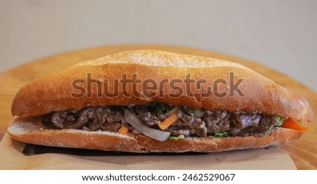 Banh mi. Vietnamese sandwich close-up, side view, selective focus. Baguette bread with beef, Beef Vietnamese sandwich. Street food. Royalty-Free Stock Photo #2462529067