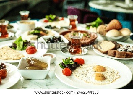 A variety of delectable dishes and cuisines presented on multiple plates arranged neatly on a table. Royalty-Free Stock Photo #2462544153