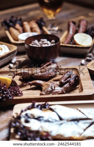 A wooden table is beautifully adorned with plates of mouthwatering food, inviting guests to savor the delectable offerings. Royalty-Free Stock Photo #2462544181