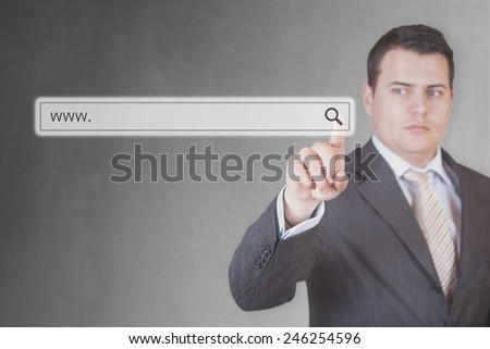 Young and handsome Businessman pushing (touching) virtual web browser address bar or search bar with loupe sign