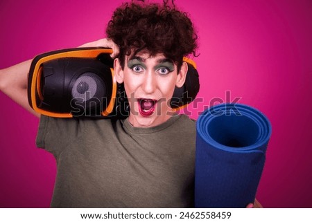 A funny guy in make-up is doing fitness. retro style. Pink background.