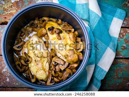  stewed chicken breast  with mushrooms in the crock-pot. Royalty-Free Stock Photo #246258088