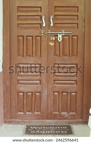 an open wooden door with a welcome sign for those who want to come and a good bye sing for those who are leaving. 
