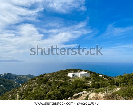 A chapel at the top of the mountain surrounded by dense vegetation. Location; Sifnos Island.