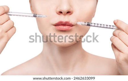 Young woman gets cosmetic injection in lips. Royalty-Free Stock Photo #2462633099