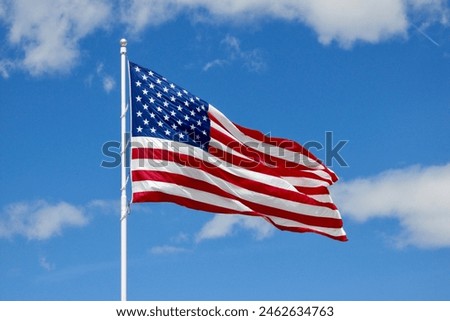 American flag waving full against blue sky                      